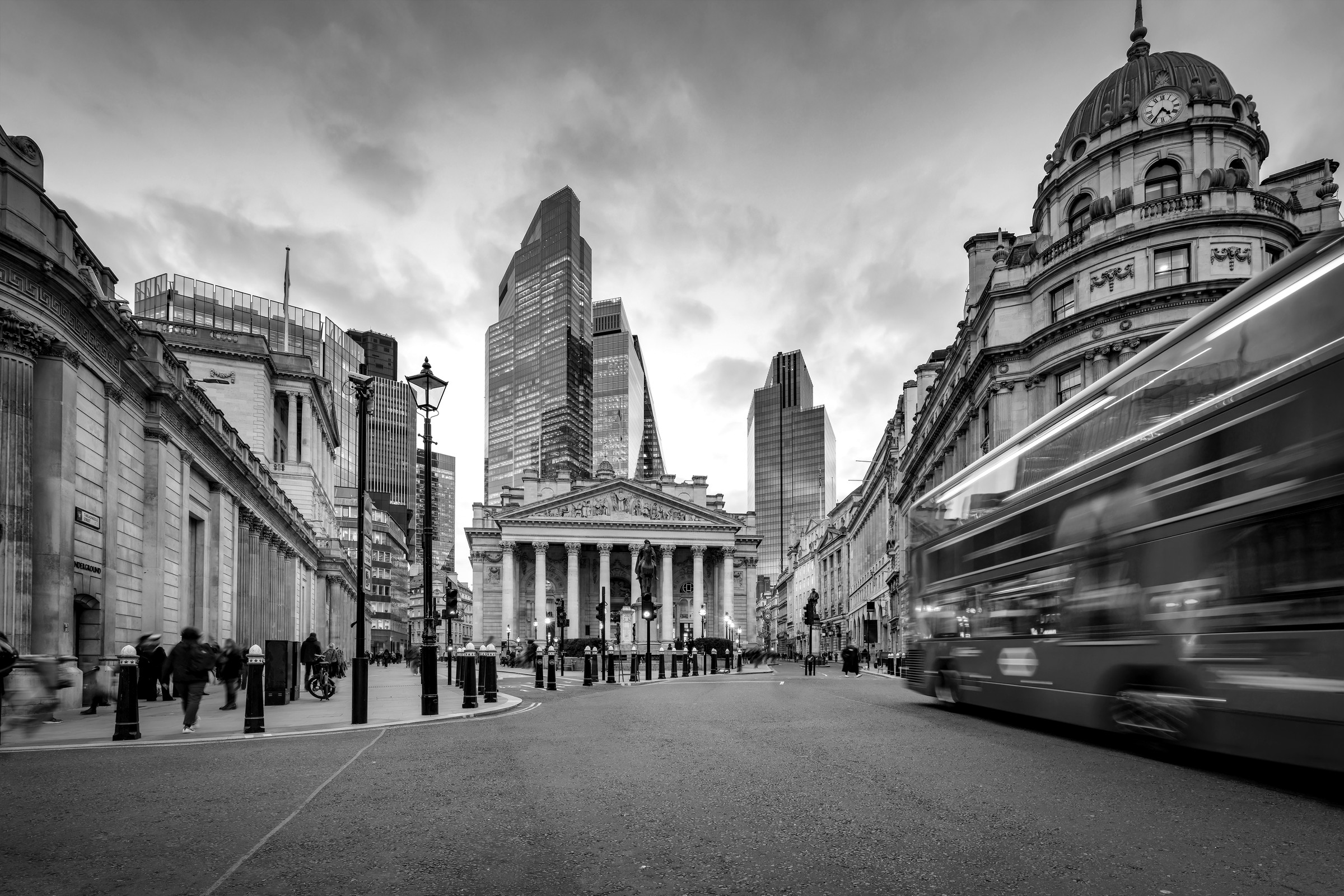 A red London double-decker bus passing the Royal Exchange and Bank junction in the City of London.